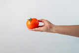 Fototapeta  - Orange fruit in hand isolated on white background.