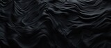 Fototapeta Do akwarium - A detailed macro shot of a black marble texture set against a dark background, creating a monochrome aesthetic reminiscent of sleek automotive tire patterns