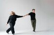 Energetic Duo Performing a Contemporary Dance Routine in a Bright White Studio