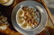 A bowl of yogurt topped with fresh bananas and crunchy granola