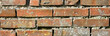 Fond d'un mur de vieilles briques oranges maçonnées, format bannière