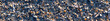 Panoramic beach background pattern with hundreds of colorful sea shells lying on the sand at low tide. Mussels, fragments of shells and sand in natural reserve and national park “Wattenmeer“ Germany.
