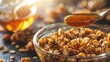A spoonful of honey drizzling over a bowl of crunchy granola.