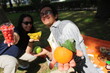 two friends out on a picnic in the garden holding healthy fresh fruits *1