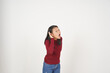 © Sino Images Studio - Young Asian woman in Red t-shirt hand on ear, cant hear you concept isolated on white background