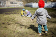 © Pavel Losevsky - Three little children play outdoor in courtyard.