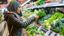Muslim Woman At Grocery Store. Amidst The Aisles, A Muslim Woman Shops For Groceries.