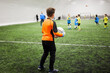 © Pavel Losevsky - Boy goalkeeper going to put the ball into play, rear side view.