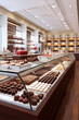Showcase full of delicious cakes and pastries in a modern bakery.
