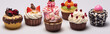 Close-up of a variety of deliciously decorated cupcakes against a white background.