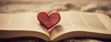 Red Fabric Heart On The Pages Of An Open Book.