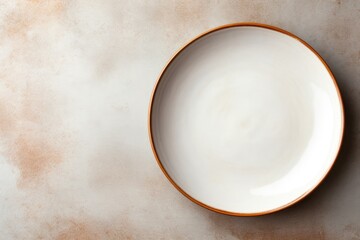 Simple white plate with brown rim on wooden table. Suitable for food and dining concepts