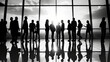 © Wasin Arsasoi - Several silhouettes of businesspeople interacting background business centrer.
