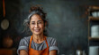 Portrait of a hispanic senior woman at the kitchen, wearing eyeglasses and an apron, smiling and friendly 
