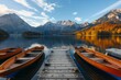 Row boats besides wooden dock in a lake 