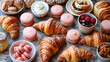 Elegant assortment of baked goods with golden croissants, delicate pink macarons and treats, concept of wedding reception, girl's party, afternoon tea party, valentine's day.