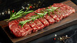 fresh raw steak meat on wooden board with rosemary and spice.