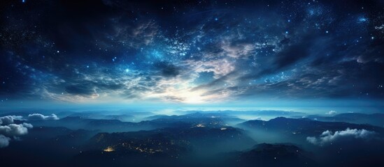 Wall Mural - A stunning natural landscape at night, with a sky full of stars and majestic mountains in the foreground. Cumulus clouds drift across the horizon, adding to the peaceful atmosphere of the scene