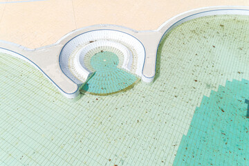 drone aerial view of a swimming pool with dirty water