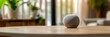 © VicenSanh - A smart speaker on a table, ready to follow voice commands, reflecting the convenience of smart home devices. Copy space.