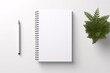 a notebook and pencil on a white surface