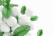 White dragees with menthol or mint and fresh mint leaves