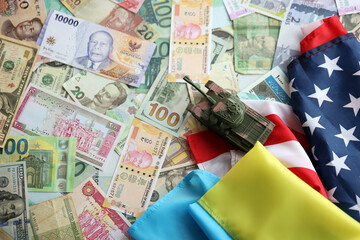 Toy tank on US flag and ukrainian flag on many banknotes of different currency. Background of war funding and military support between United States and Ukraine