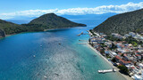 Fototapeta Na drzwi - Aerial drone photo of famous seaside village small port and long sandy beach of Tolo with hotels and resorts built by the sea, Argolida, Peloponnese, Greece