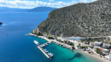 Fototapeta Na drzwi - Aerial drone photo of famous seaside village small port and long sandy beach of Tolo with hotels and resorts built by the sea, Argolida, Peloponnese, Greece