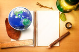 Fototapeta Desenie - Natural and Save Earth observer concept, globe Earth, Notebook, pencil, lamp, loop and ruler on wood table Elements of this image furnished by NASA