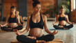 © Анастасия Козырева - A group of pregnant women in sportswear doing yoga in the gym