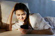 © SHOTPRIME STUDIO - Young woman attractive smartphone phone bedroom female beauty lifestyle home internet lying bed caucasian