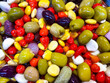 Assorted marinated olives, peppers, small cucumbers and garlic in oil close-up