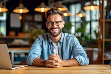 Wall Mural - Happy businessman sitting at desk, casual clothing