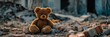 Teddy bear is abandoned in an area destroyed by war. A toy in a devastated urban zone.