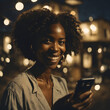 Mujer afroamericana sonriendo viendo el celular en su mano de noche en la ciudad