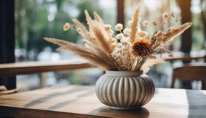 Wall Mural - close up of dried flowers are placed in a decorative vase in the cafe