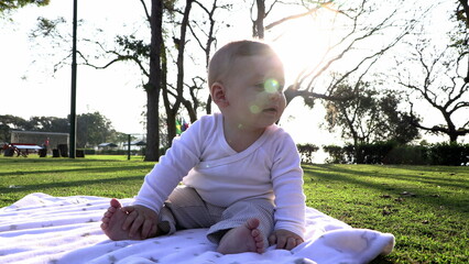 Canvas Print - Child baby seated at park during sunset