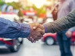 Customer shake hand with auto insurance agents after agreeing to terms of insurance with blurred car on background 