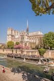 Fototapeta Paryż - Paris, Notre Dame cathedral with boat on Seine in France