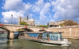 Fototapeta Miasta - Paris, Notre Dame cathedral with boat on Seine in France
