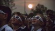 Children in Awe of a Solar Eclipse. Group of children wearing protective sunglasses, looking up in wonder at a solar eclipse.