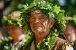 Portrait of happy Man with oak crown in traditional outfit at midsummer festival