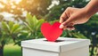 female hand put red paper heart into slot of white donation box charity donation election fundraising help love gratitude concept