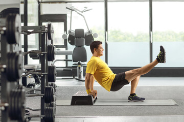 Canvas Print - Man exercising with a step aerobic platform