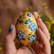 Easter egg in hands, macro