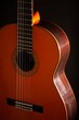 © Robert Peak - Classical Spanish flamenco guitar close up, dramatically lit isolated on black background with copy space.