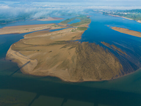 The island is built up by sand in the river with an aerial view. Natural landscape.