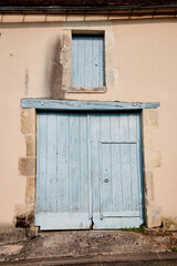 Wall Mural - Closed Large Door with Small Inset Door with Window Shudder Above