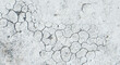 Textured background of concrete, or cracked white earth, suitable for concepts related to drought, environmental issues, or as a backdrop with space for text
